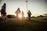 A team of women rugby players make their way across the pitch