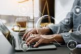 Anti-money laundering graphic over an image of justice scales and a laptop