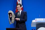 Shadow justice secretary Robert Jenrick removes a judge's wig from a black box as he delivers a speech during the Conservative Party Conference, Manchester, 2025