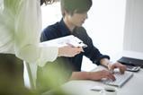 A young male office worker and his colleague