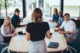 A woman leads a team meeting