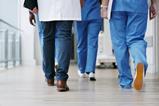 Hospital staff walk down the corridor