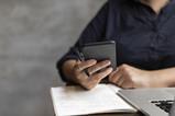 Student studying using phone and laptop