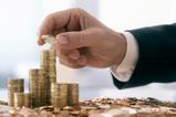 Businessman stacking coins