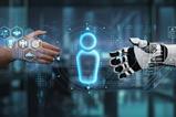 Human hand reaches out to shake robot hand