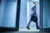 A businessman walks out of an office