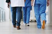 Hospital staff walk down the corridor