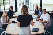A woman leads a team meeting