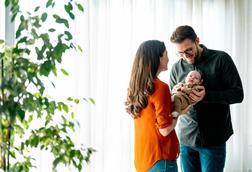 Couple cradle their newborn