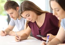 A student checks her phone during school exam