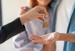 Couple receiving keys to new home