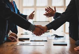 Two parties shake hands in a business meeting