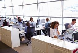 Colleagues working at their desks in an open-plan office