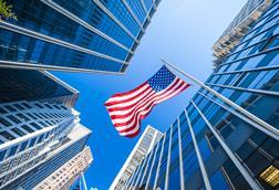 US flag amongst city skyscrapers