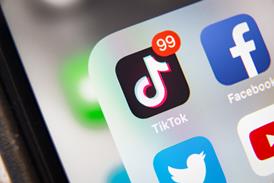 TikTok app logo shown on phone