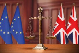 Justice scales with EU and UK flags