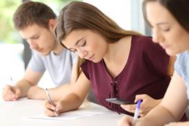 A student checks her phone during school exam