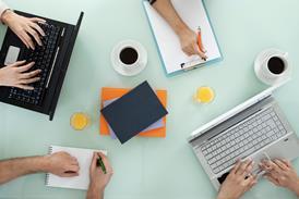 Colleagues working together on laptops and making notes