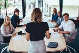 A woman leads a team meeting