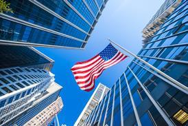 US flag amongst city skyscrapers