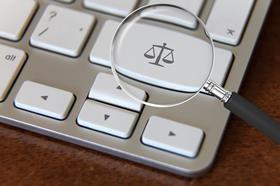 Justice scales on computer keyboard