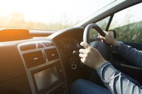 An anonymous man driving a car