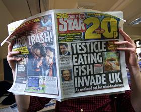 Tabloid newspaper reader