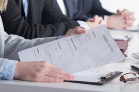 A panel of interviewers read a CV