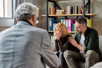 A crying client is comforted during a meeting
