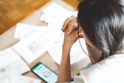 A woman looks at bills and statements