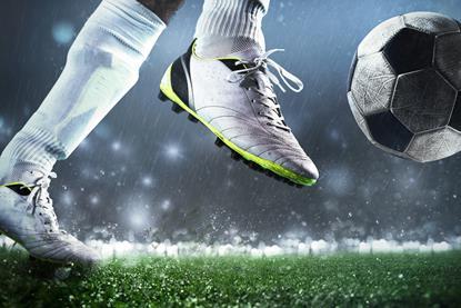 Close up of footballer kicking the ball