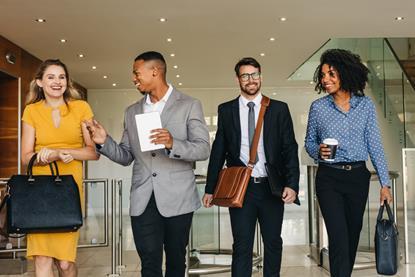 Colleagues walk through the office together