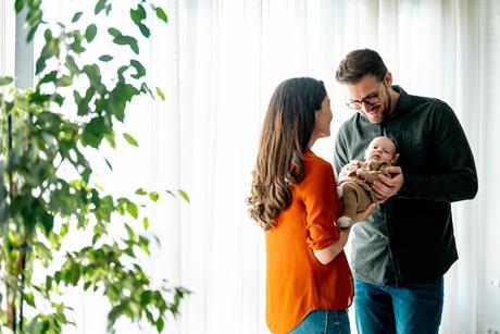 Couple cradle their newborn