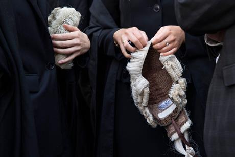 Barristers hold their wigs