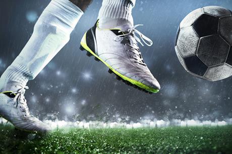 Close up of footballer kicking the ball