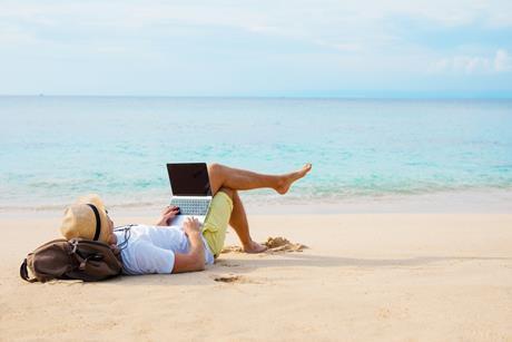 Man checking emails on the beach