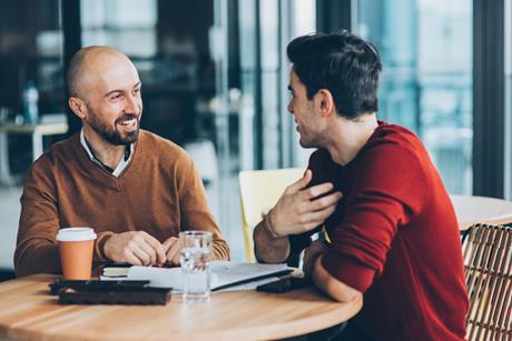 Two male colleagues chat together