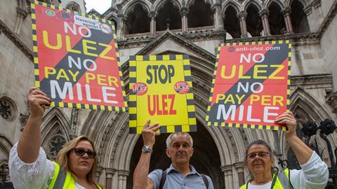 Activists stage a protest outside the Royal Courts of Justice as the High Court decides in favor of London mayor Sadiq Khan in a lawsuit against the Ultra Low Emission Zone expansion
