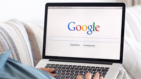 Man uses Google on laptop