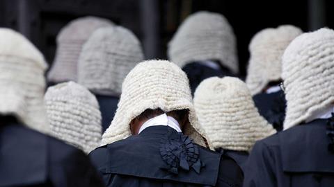 A group of judges wearing wigs and gowns