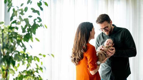 Couple cradle their newborn