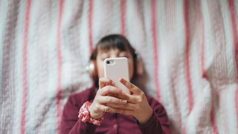 Child scrolling on social media on phone