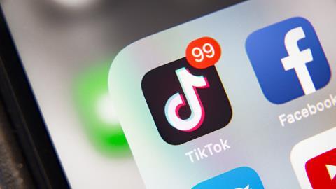 TikTok app logo shown on phone