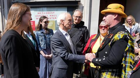 Sir Brian Langstaff (left), chairman of the infected blood inquiry, with victims and campaigners outside Central Hall in Westminster, London, after the publication of the Inquiry report