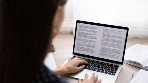A woman reads a digital will on a laptop
