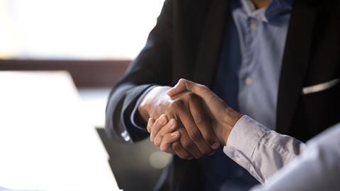 Businessmen shaking hands after signing contract