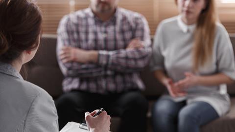 An anonymous couple sit with their lawyer