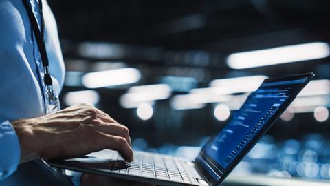 Office worker typing on laptop