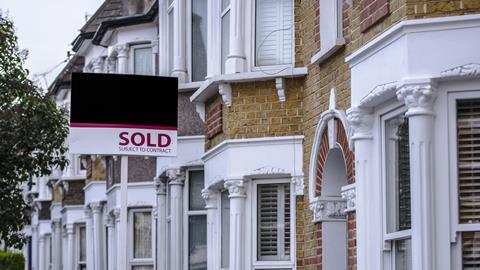 Sold sign outside row of terraced houses
