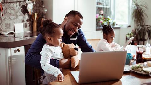 A father juggles childcare with home working